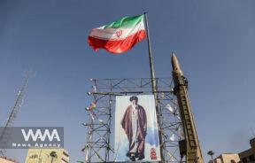 An Iranian missile system is displayed next to a banner with a picture of Iran's Supreme Leader Ayatollah Ali Khamenei, to showcase Iran's authority during the Iranian defence week, in a street