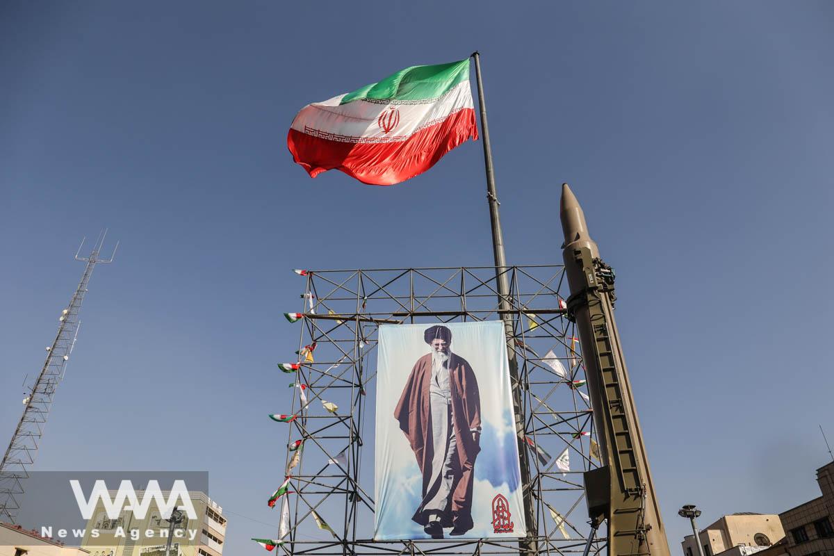 An Iranian missile system is displayed next to a banner with a picture of Iran's Supreme Leader Ayatollah Ali Khamenei, to showcase Iran's authority during the Iranian defence week, in a street