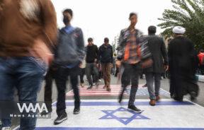 Iranians step on the U.S. and Israeli flags during the 45th anniversary of the U.S. expulsion from Iran