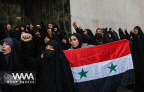 A group of Iranian students attend a gathering to protest against the Turkish government's claim of backing the Islamist militant group Hayat Tahrir al-Sham (HTS) outside of the Turkish Embassy in Tehran