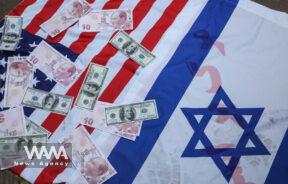 U.S dollar and Turkish lira bills are seen on the flags of Israel and the U.S during a gathering to protest against the Turkish government's claim of backing the Islamist militant group Hayat Tahrir al-Sham (HTS) outside of the Turkish Embassy in Tehran