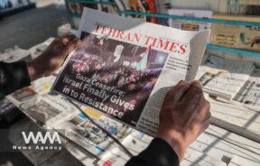 An Iranian man looks at a newspaper after the news of a ceasefire between Hamas and Israel, in Tehran, Iran, January 16, 2025. Majid Asgaripour/WANA (West Asia News Agency)